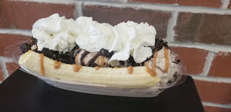 Banana split with whipped cream, Oreo and caramel drizzle