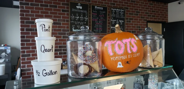 Pint, quart and half gallon take-home containers and dipped cones on the Tots counter